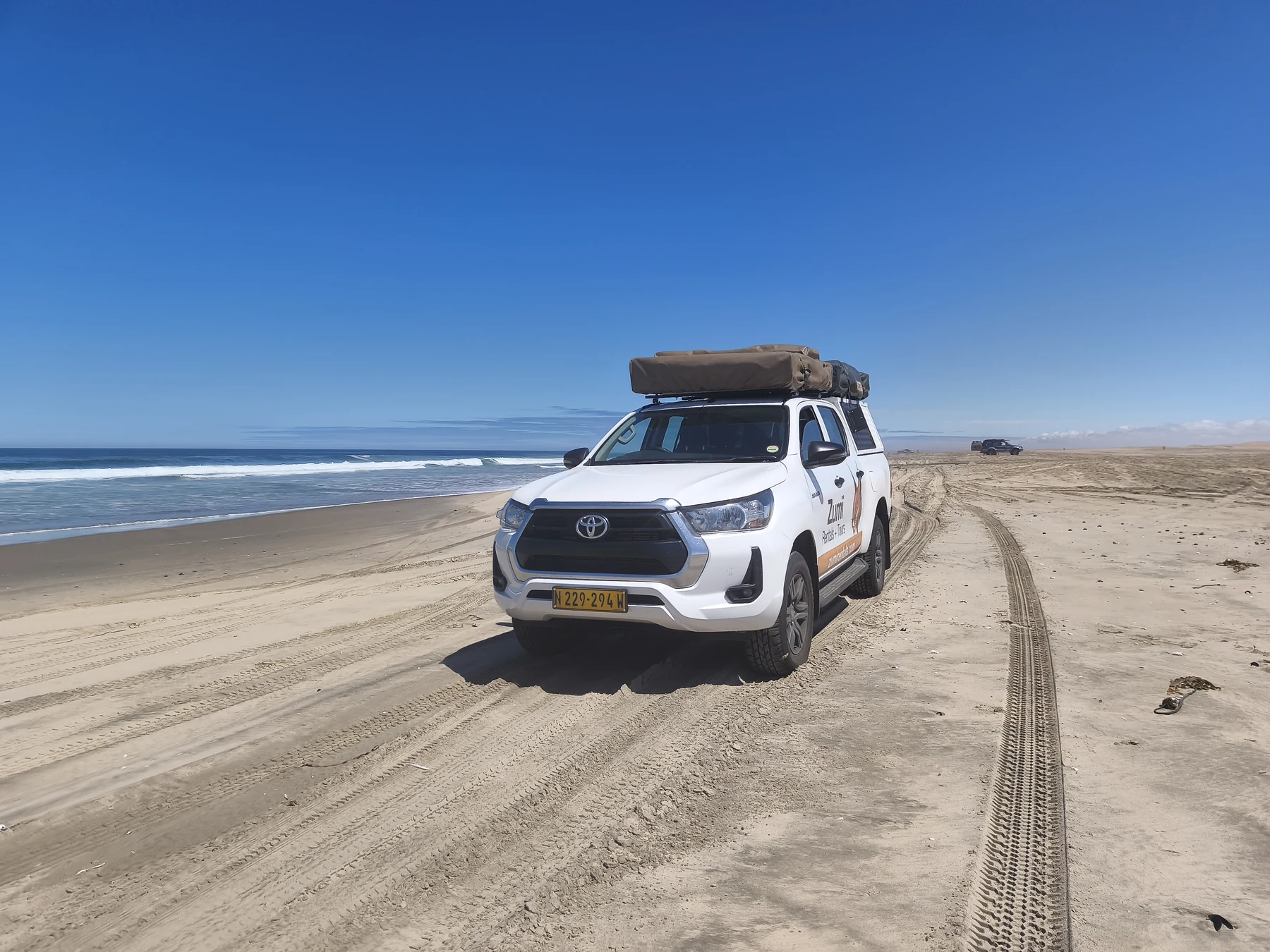Zumi Hilux on Namibia’s central coast beach, illustrative of coastal driving conditions